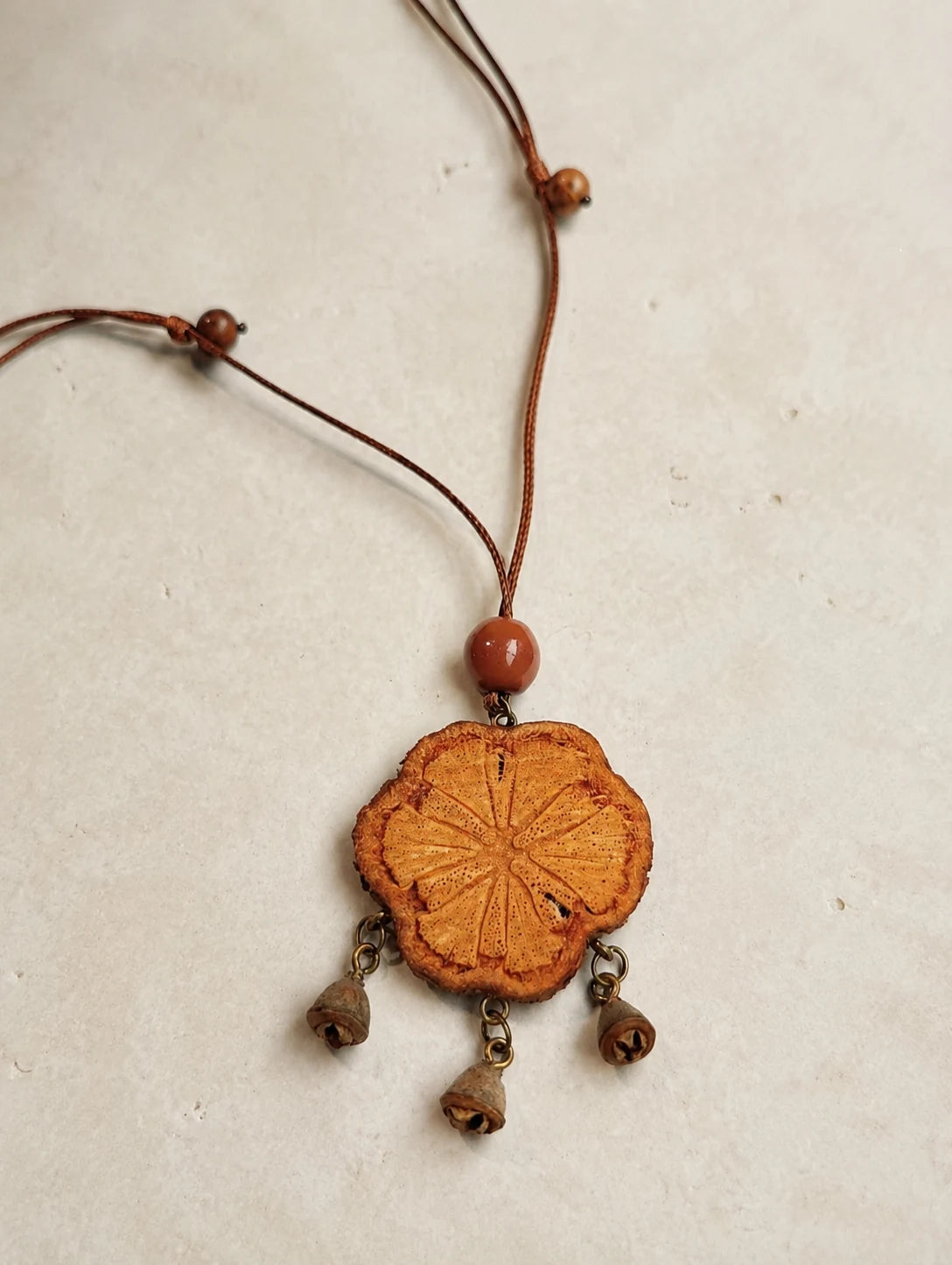 Carved Wood Tassel Necklace — close detail view