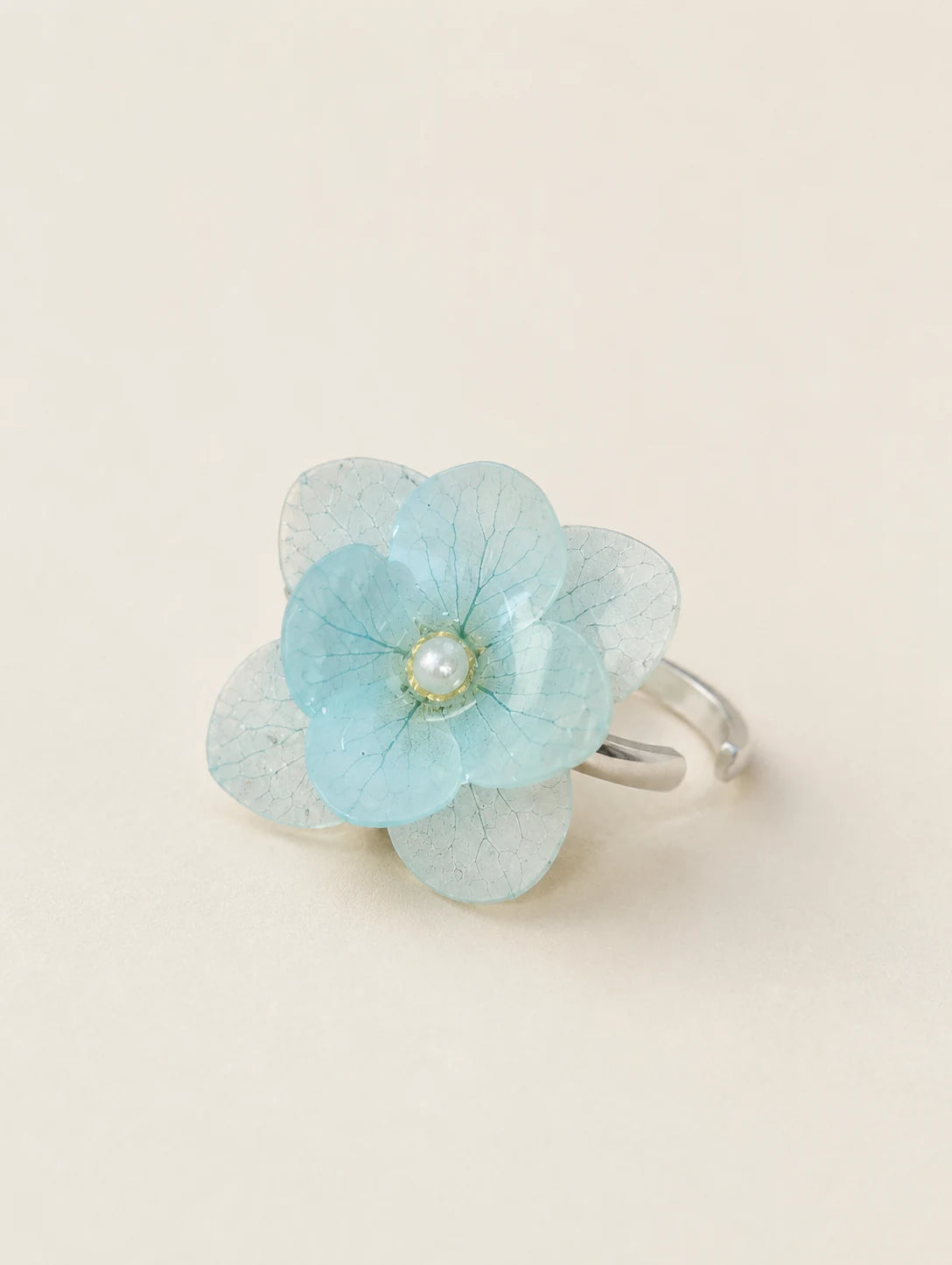 Sky Blue Petal Cluster Ring — complete product view on a warm ivory background