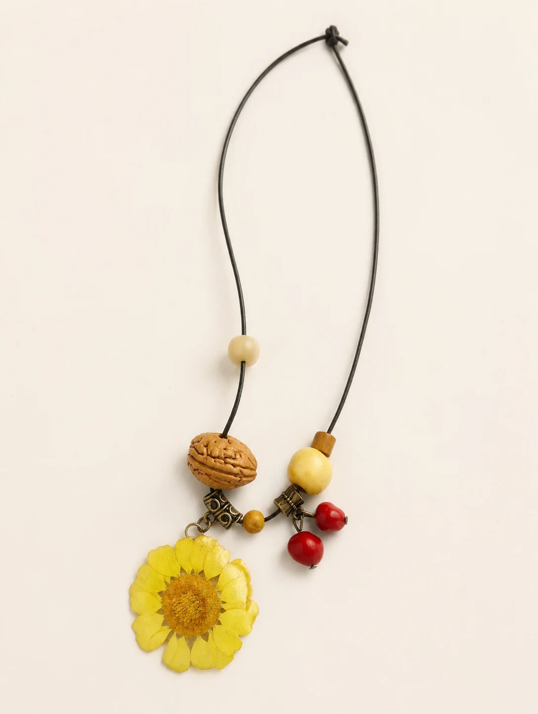 Yellow Round Petal Necklace — complete product view on a warm ivory background