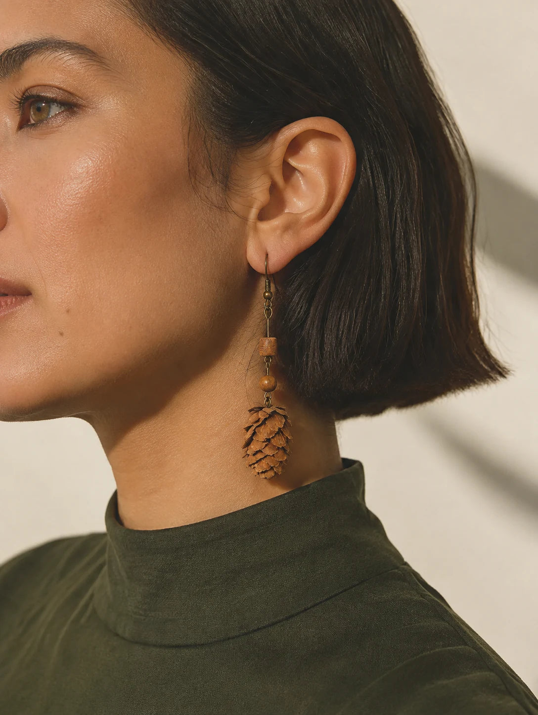 Editorial model styling the Asymmetrical Woodland Cone Earrings