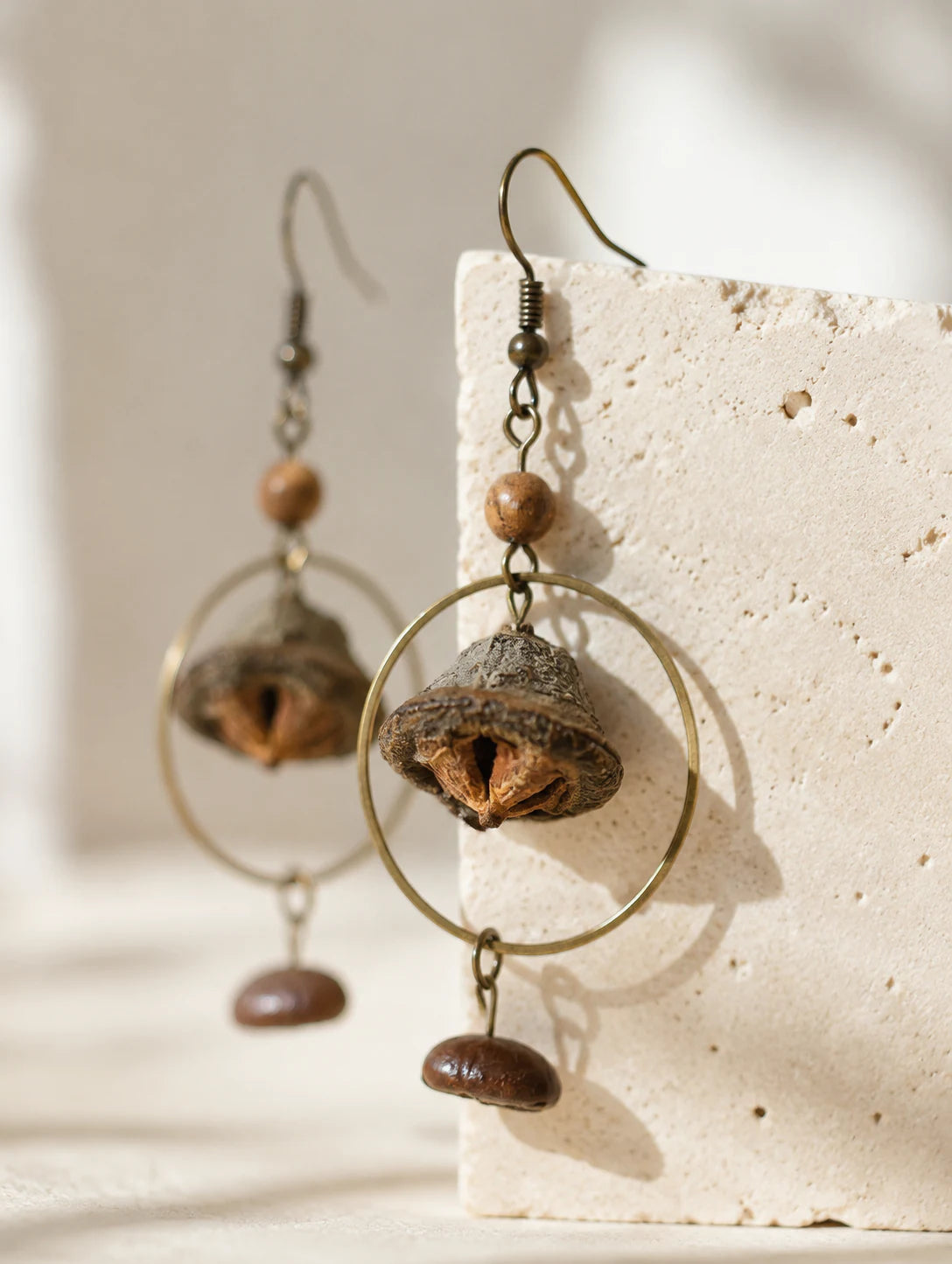 Bell Pod and Bean-Silhouette Earrings — detail view