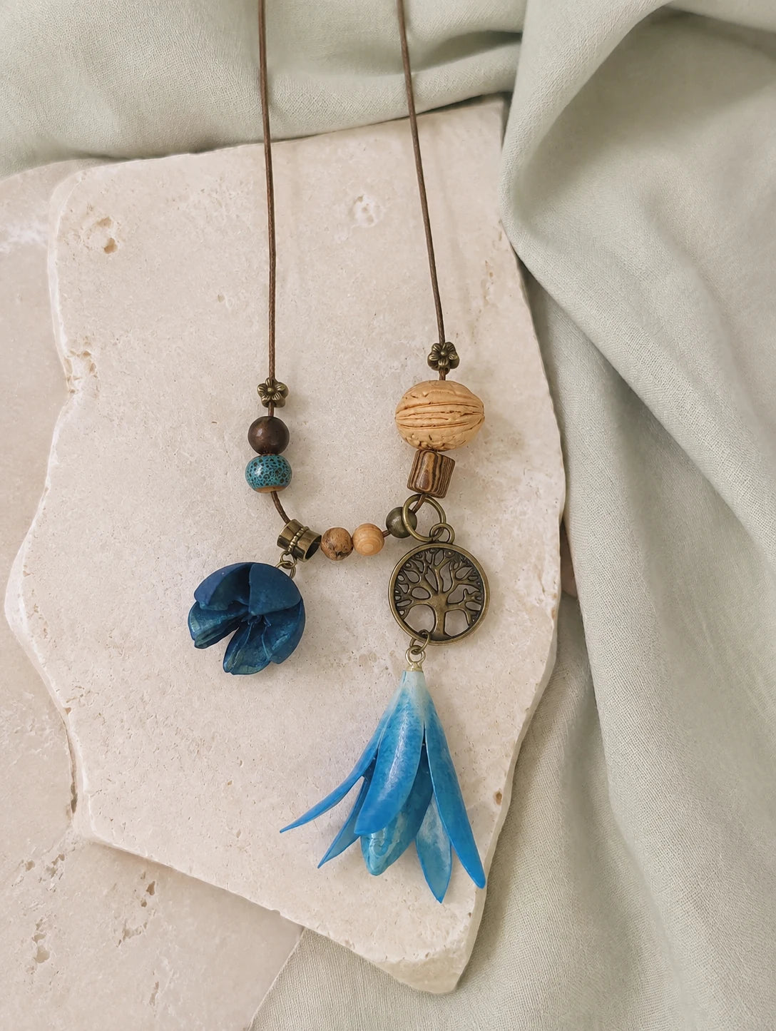 Blue Bell Petal Necklace — restrained editorial still life