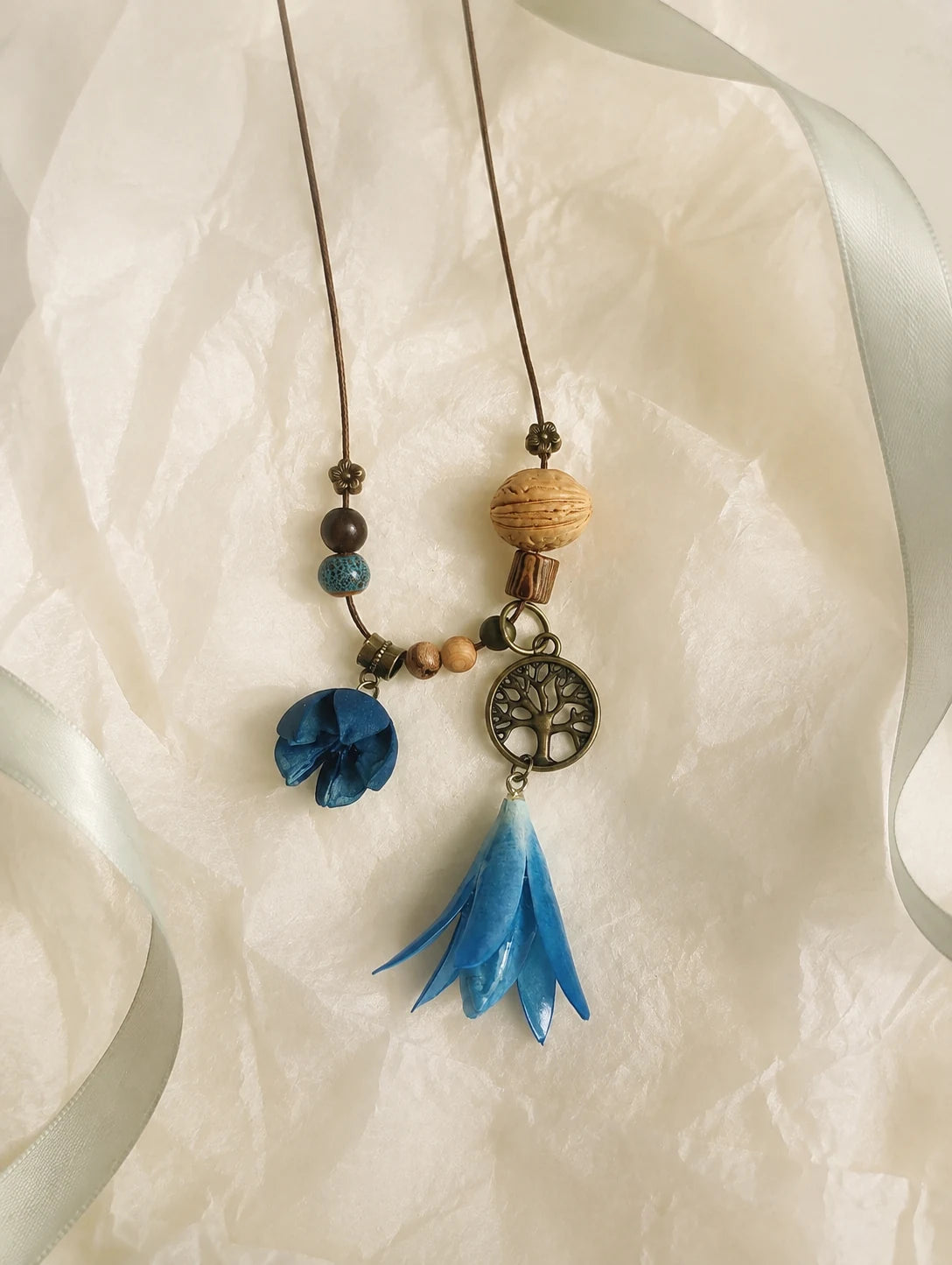 Blue Bell Petal Necklace — unbranded gift-context still life
