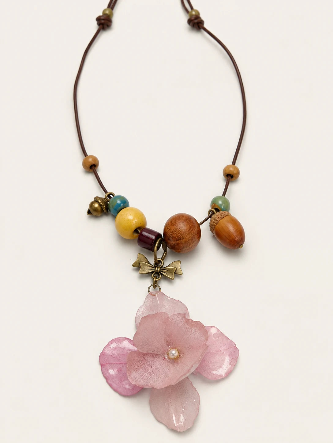 Blush Petal Cluster Necklace — complete product view on a warm ivory background