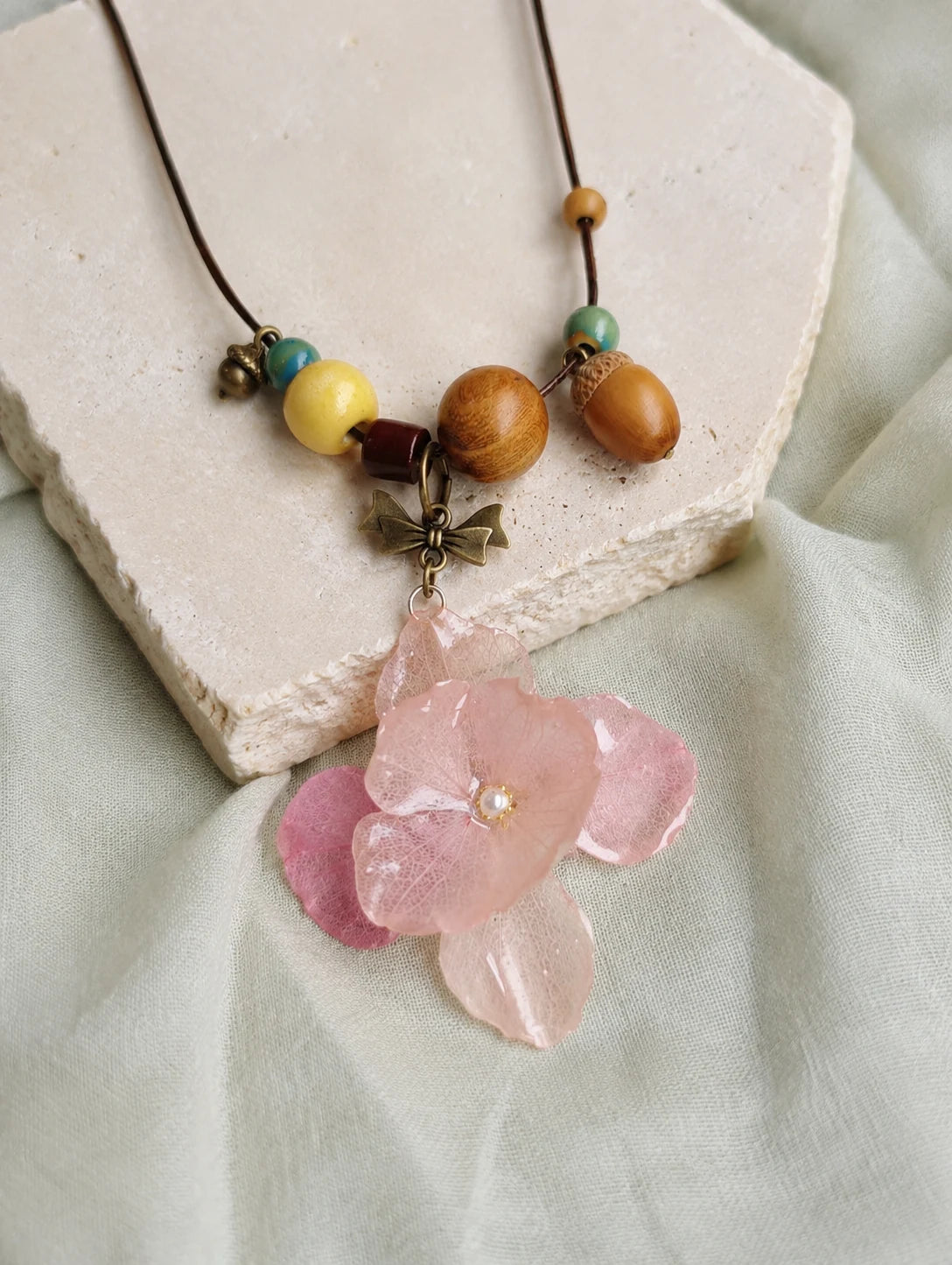 Blush Petal Cluster Necklace — restrained editorial still life
