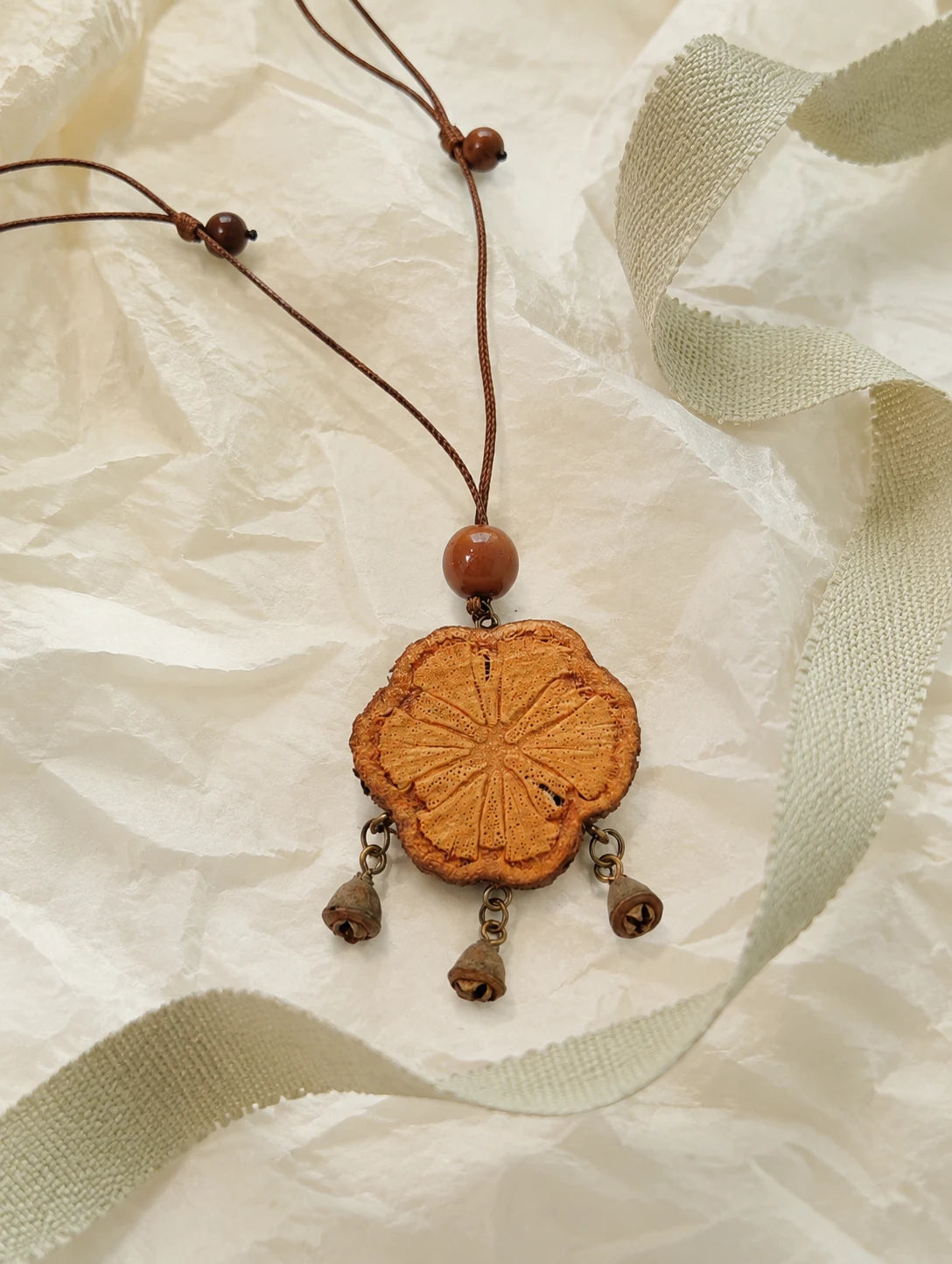 Carved Wood Tassel Necklace — unbranded gift-context still life