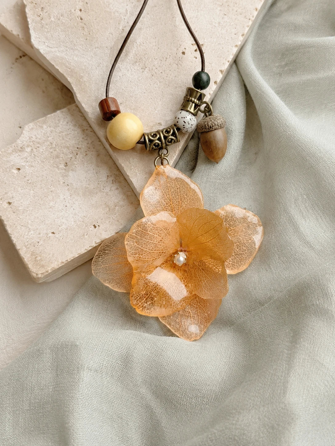 Champagne Petal Cluster Necklace — restrained editorial still life