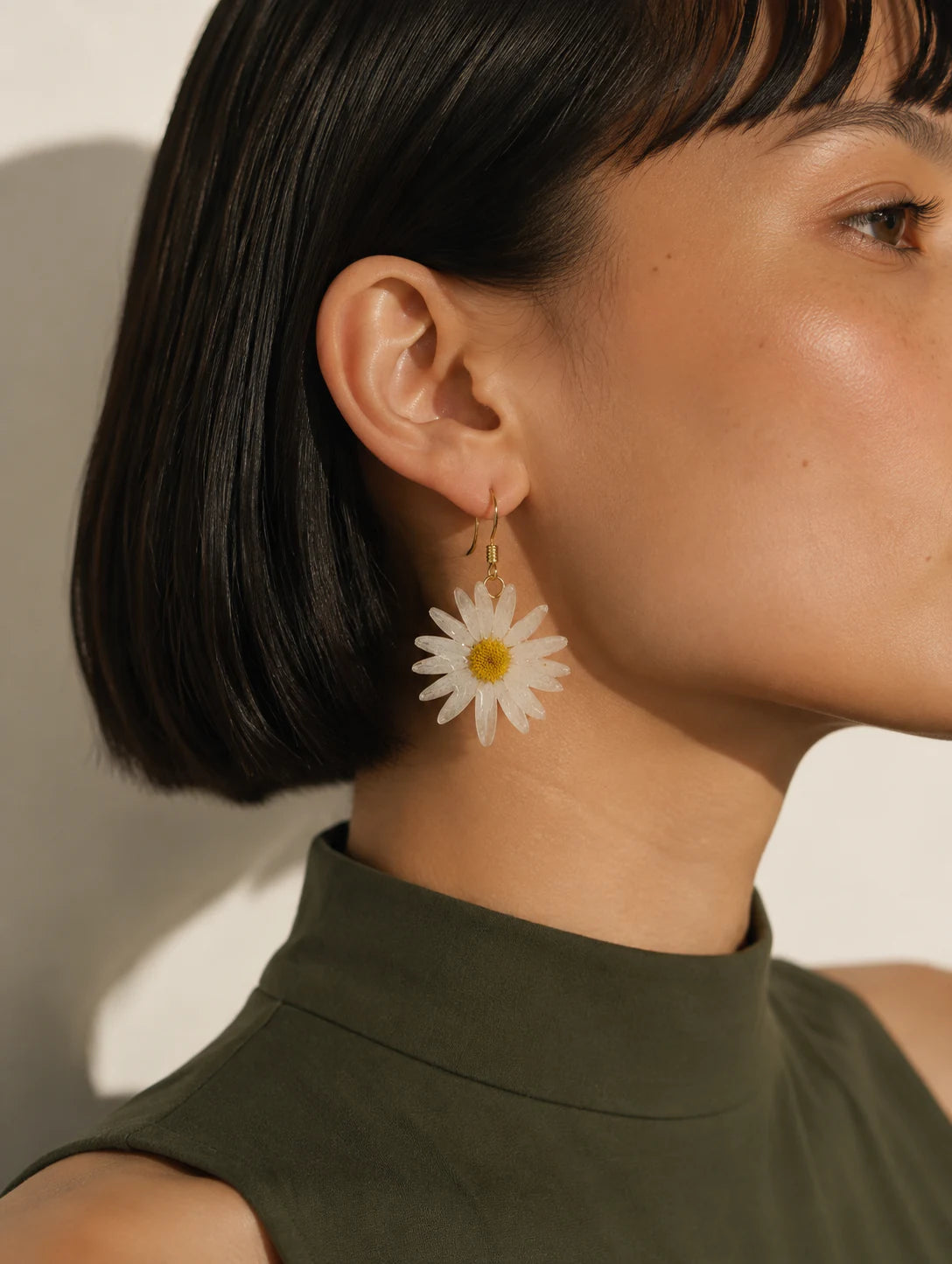 Editorial model styling the Cream Petal Drop Earrings