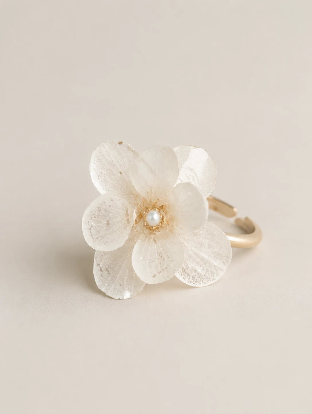 Cream Petal Cluster Ring — complete product view on a warm ivory background