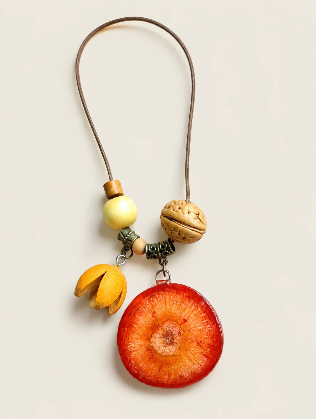 Deep Orange Slice Necklace — complete product view on a warm ivory background