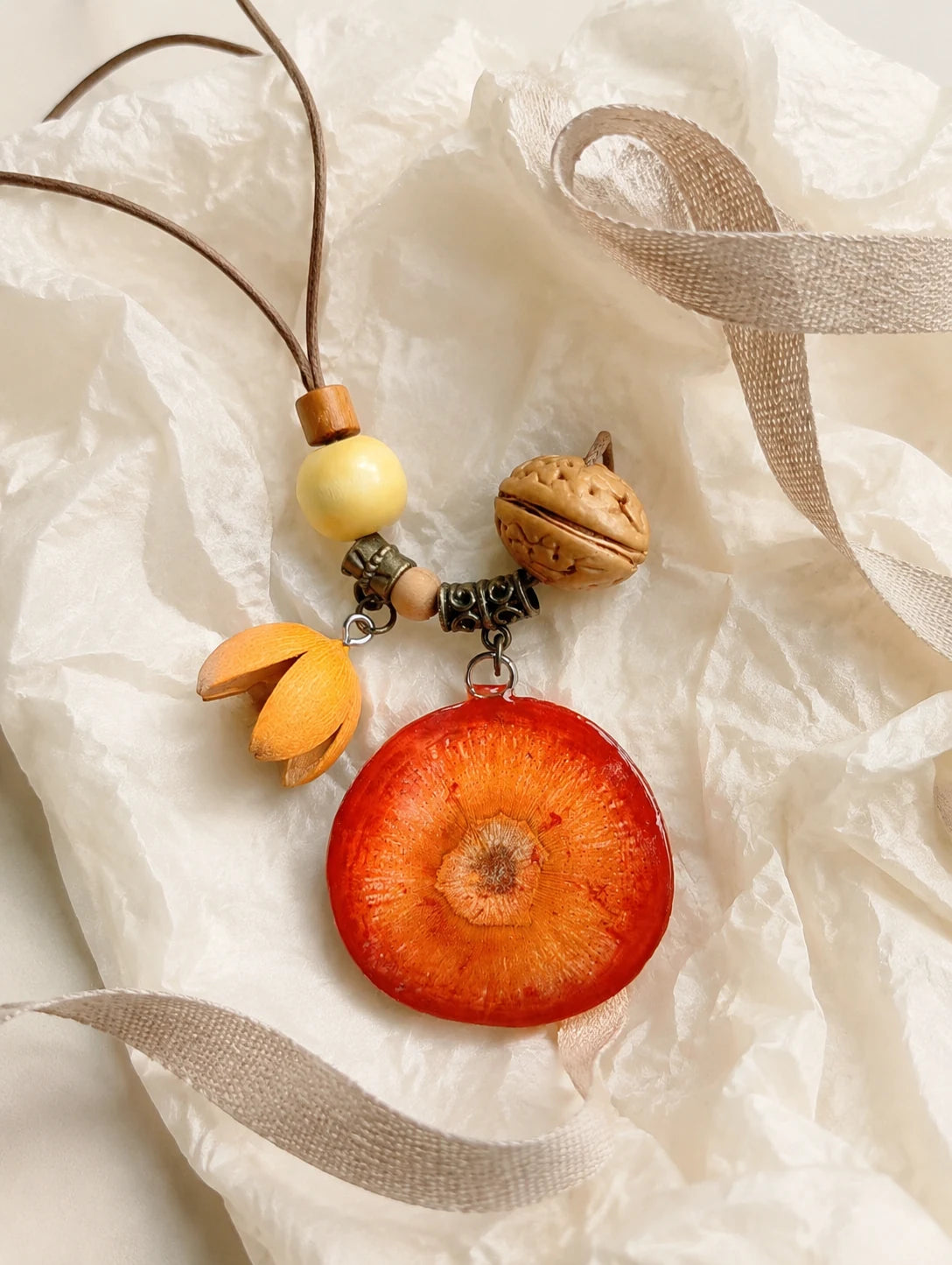 Deep Orange Slice Necklace — unbranded gift-context still life