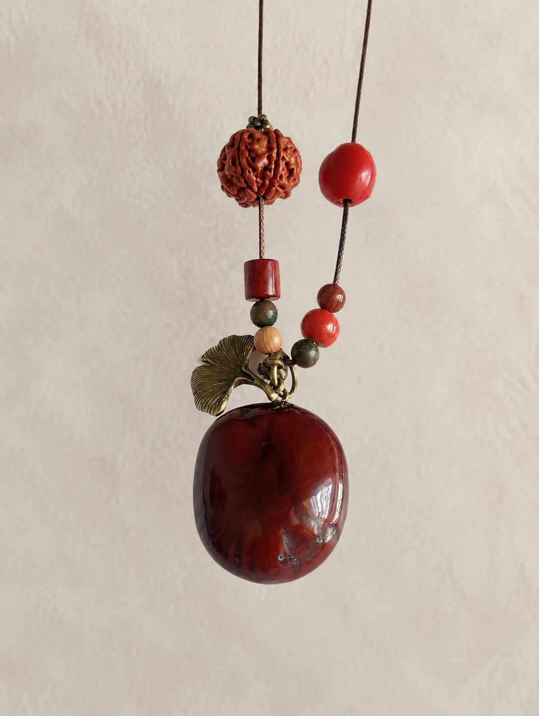 Deep Red Seed Pendant Necklace — close detail view