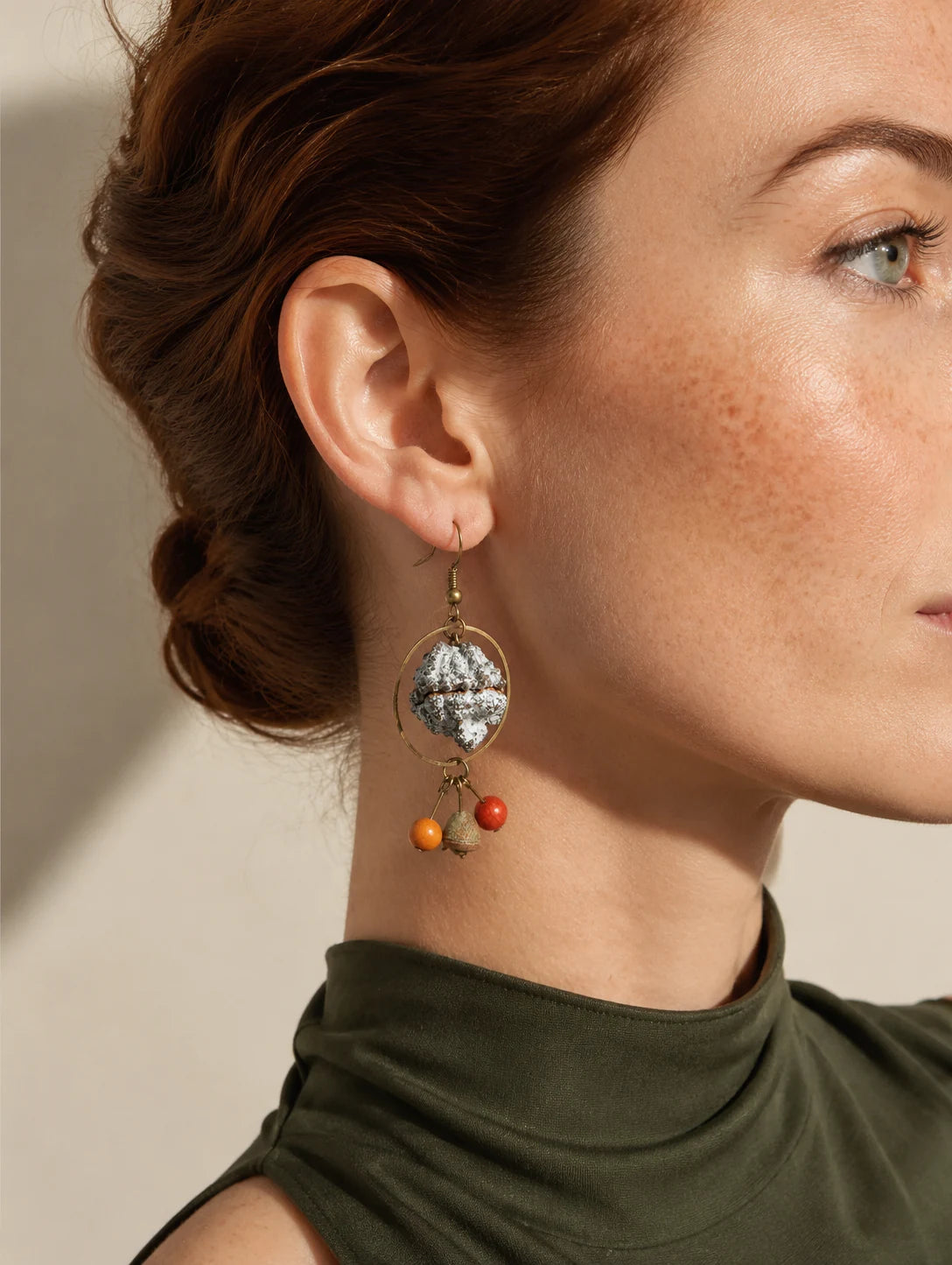 Editorial model styling the Round Seed-Pod Drop Earrings