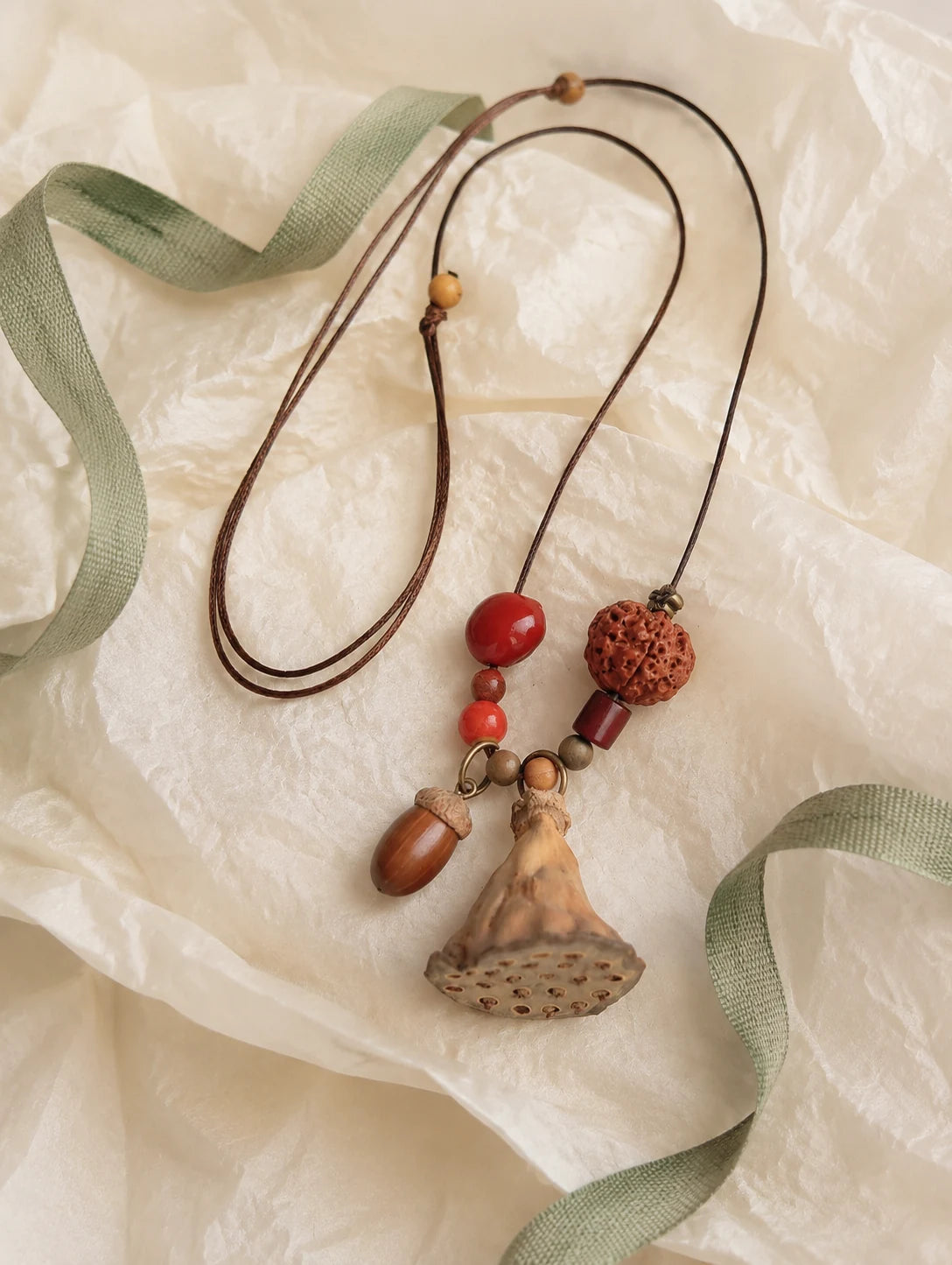 Fan Pod and Acorn Necklace — unbranded gift-context still life