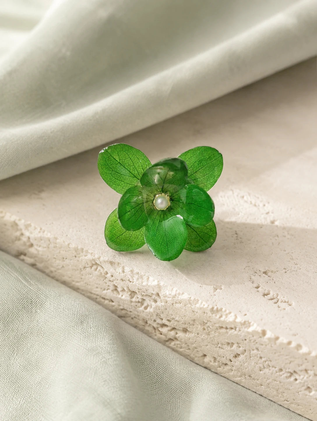 Forest Green Petal Cluster Ring — restrained editorial still life