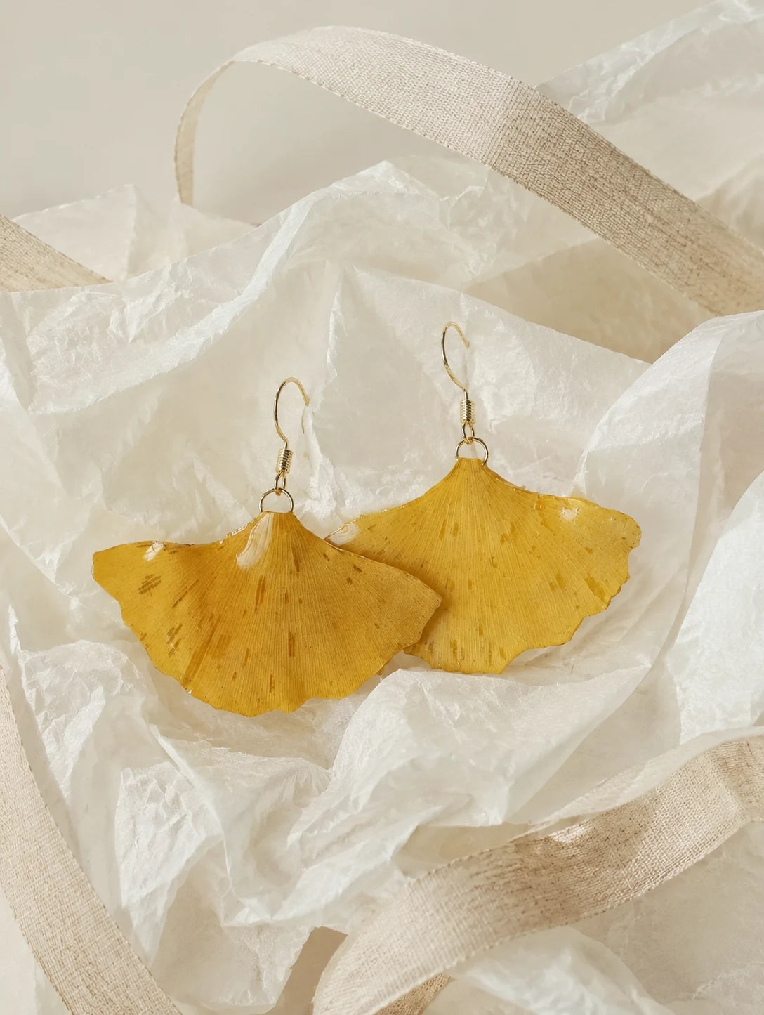 Golden Fan Leaf Drop Earrings — unbranded gift-context still life