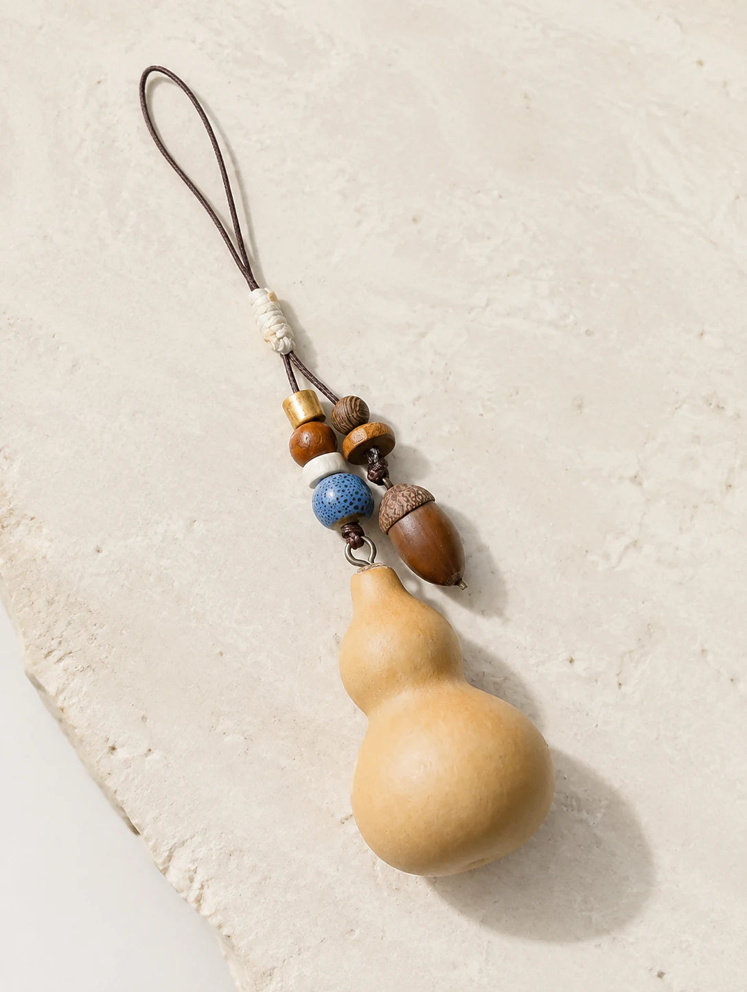 Gourd and Seed Phone Charm — hero view