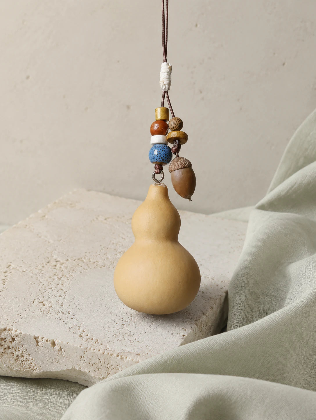 Gourd and Seed Phone Charm — styled view