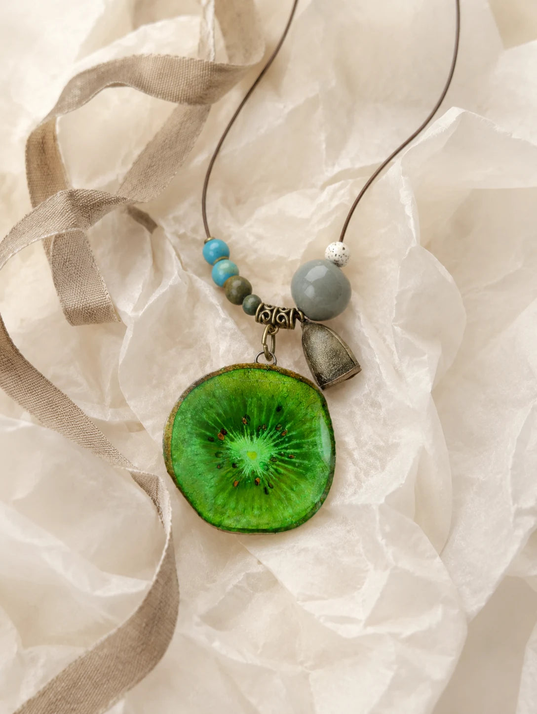 Green Slice and Bead Necklace — unbranded gift-context still life