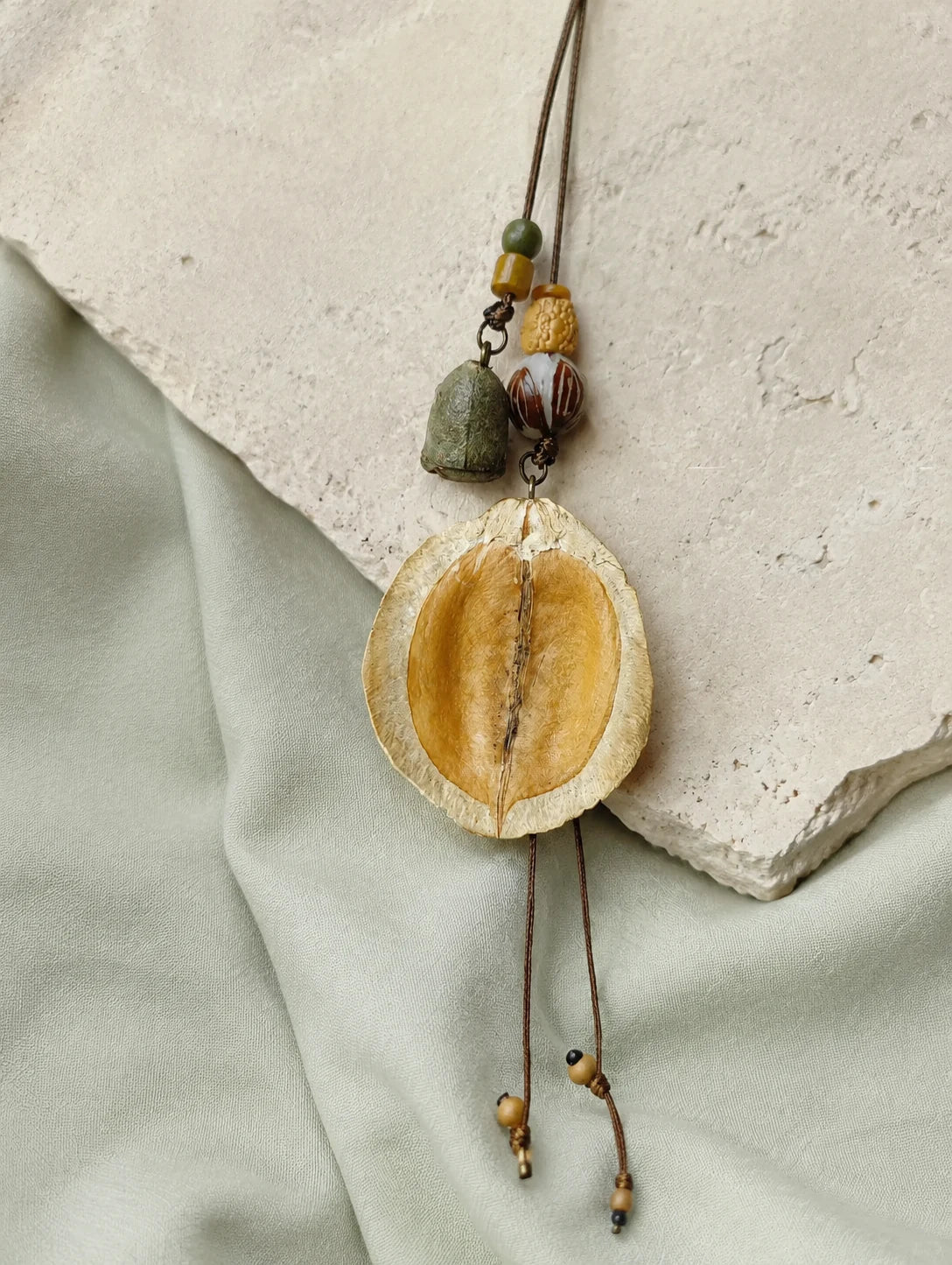 Curved Seed-Pod Pendant Necklace — styled view
