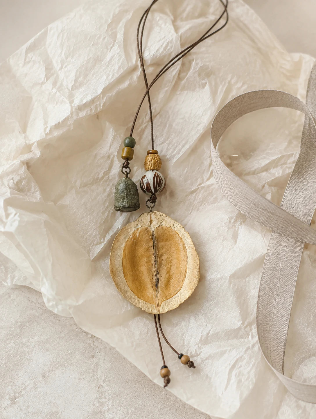 Curved Seed-Pod Pendant Necklace — gift styling