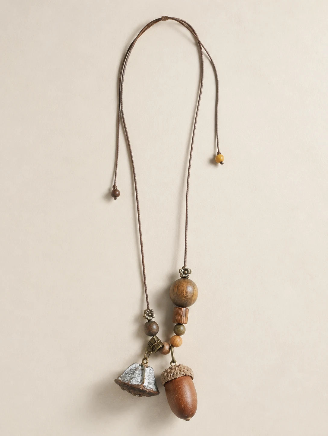 Long Acorn Cluster Necklace — complete product view on a warm ivory background