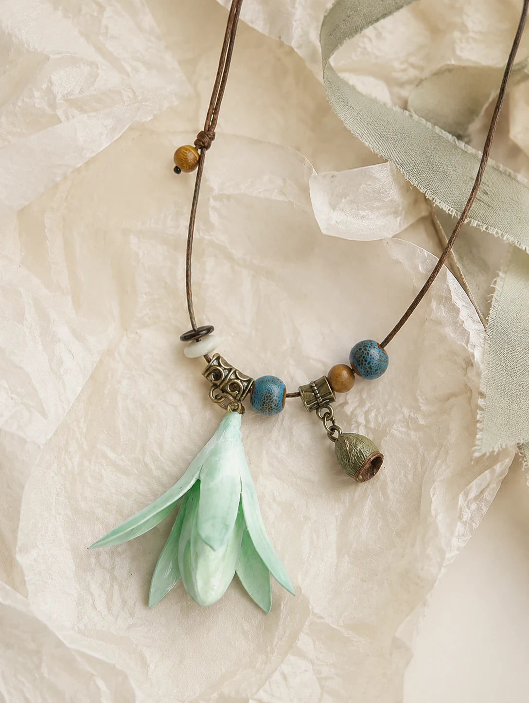 Mint Bell Petal Pendant Necklace — unbranded gift-context still life