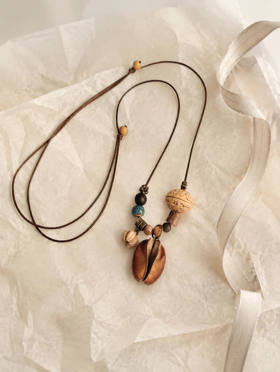 Mixed Woodland Token Necklace — unbranded gift-context still life