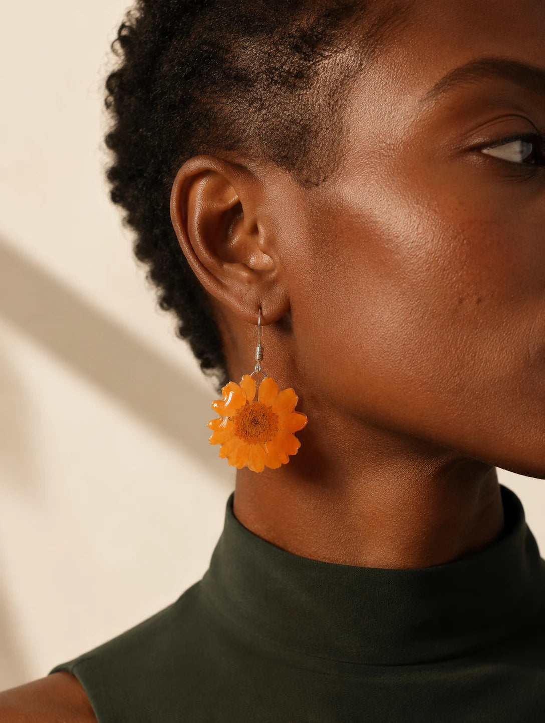Editorial model styling the Orange Petal Drop Earrings