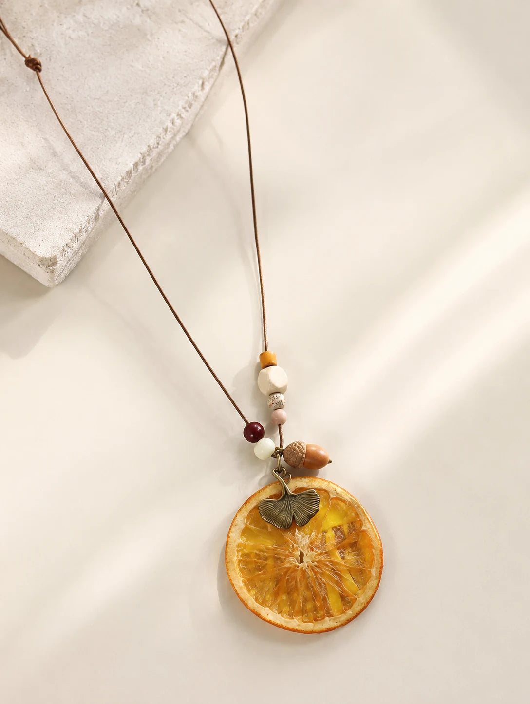 Orange Disc and Acorn Necklace — close detail view