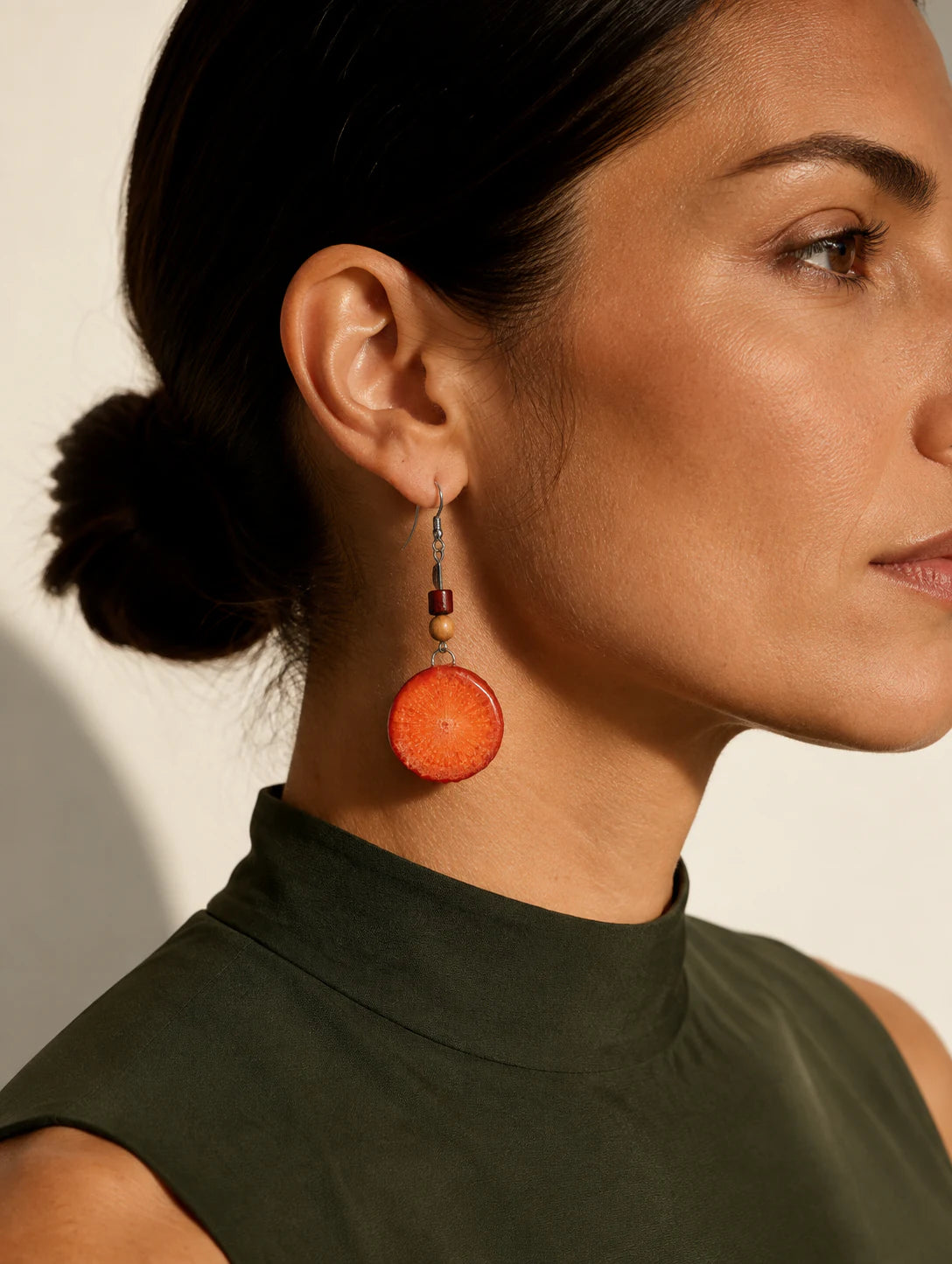 Editorial model styling the Orange Slice Drop Earrings