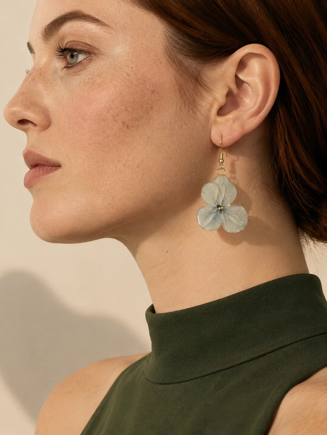 Editorial model styling the Pale Blue Cluster Petal Earrings