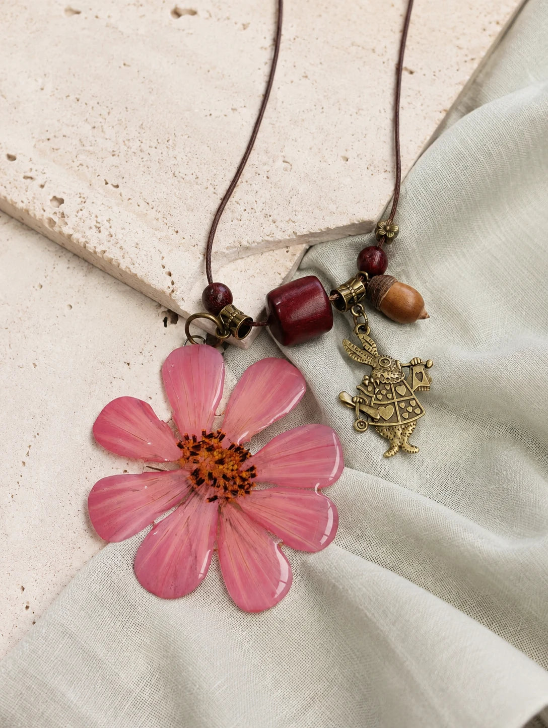 Pink Petal Pendant Necklace — restrained editorial still life