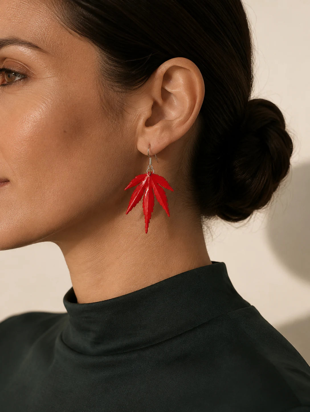 Editorial model styling the Red Leaf Drop Earrings
