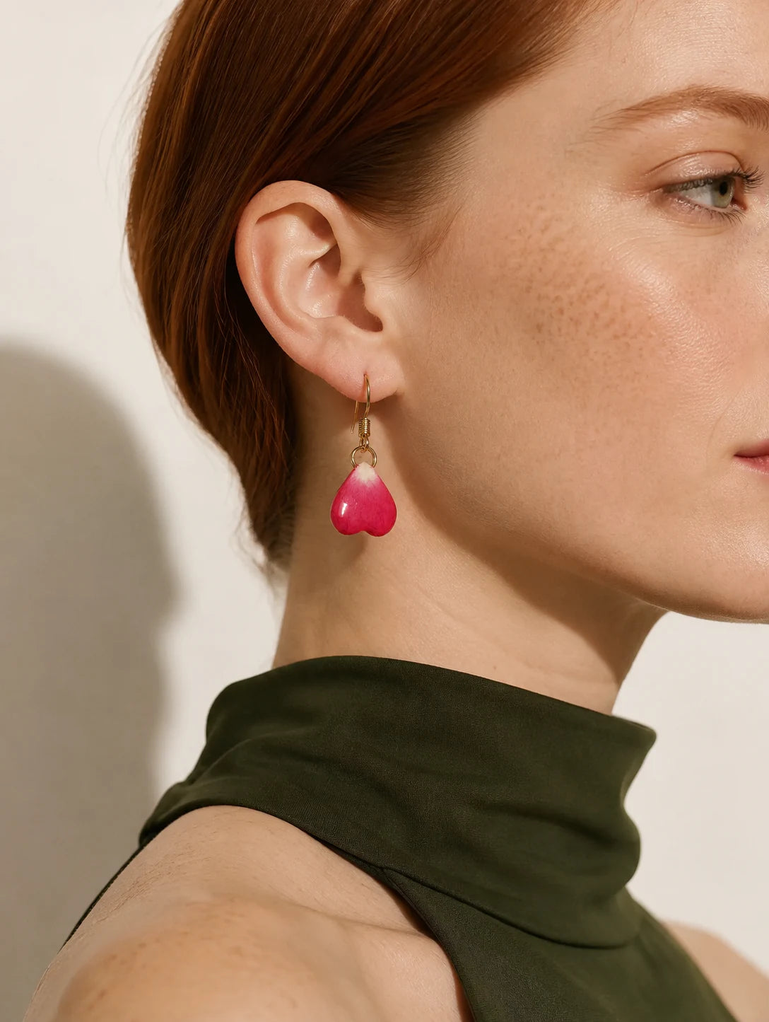 Editorial model styling the Burgundy Heart Petal Drop Earrings