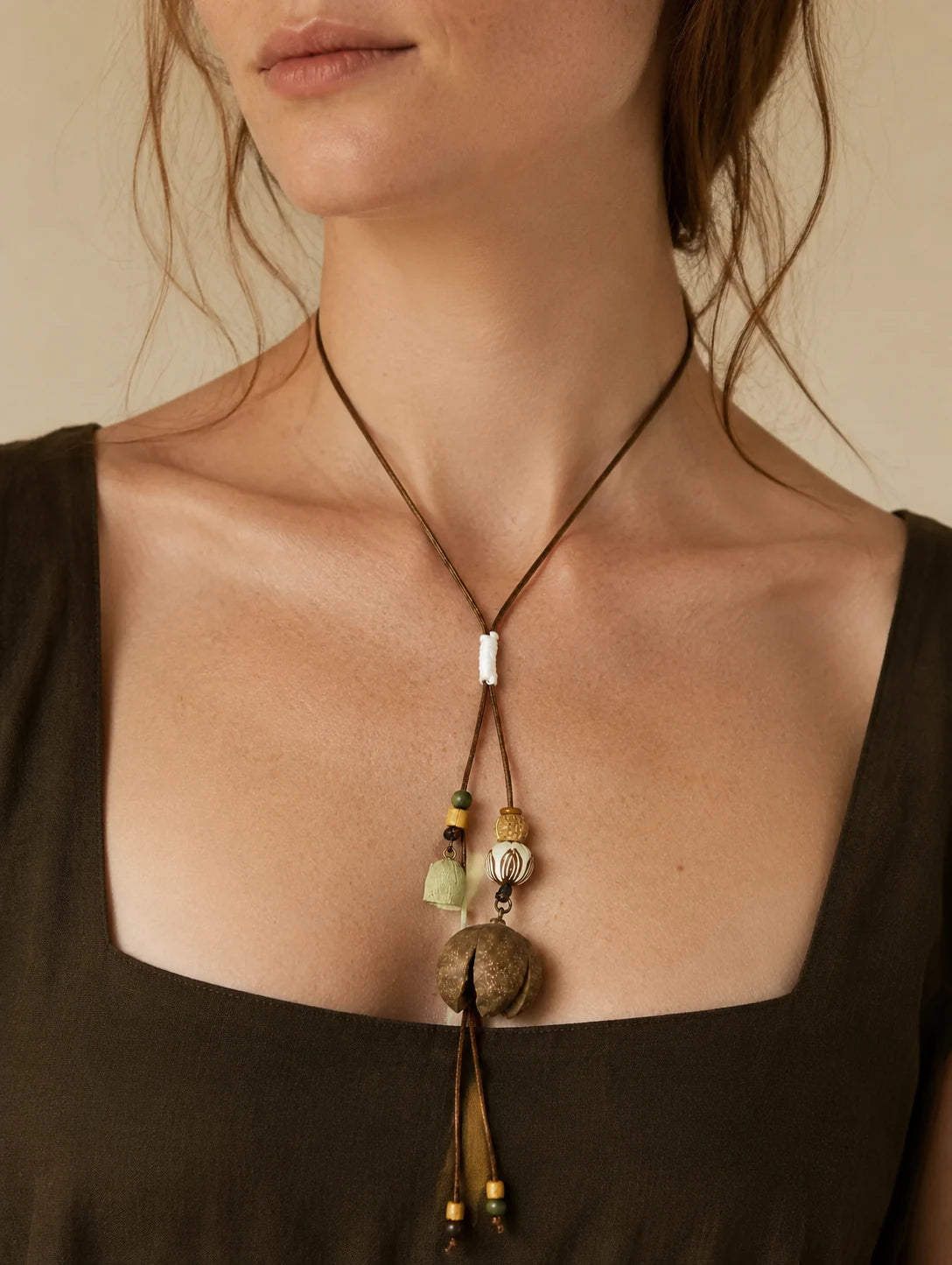 Editorial model styling the Round Woodland Pod Pendant Necklace