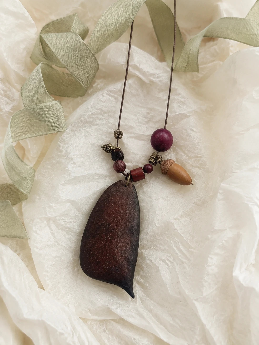 Seed Pod and Acorn Necklace — unbranded gift-context still life