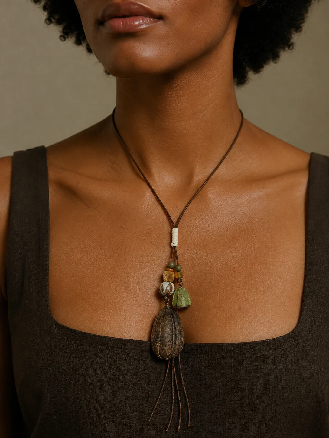 Editorial model styling the Textured Seed-Pod Pendant Necklace