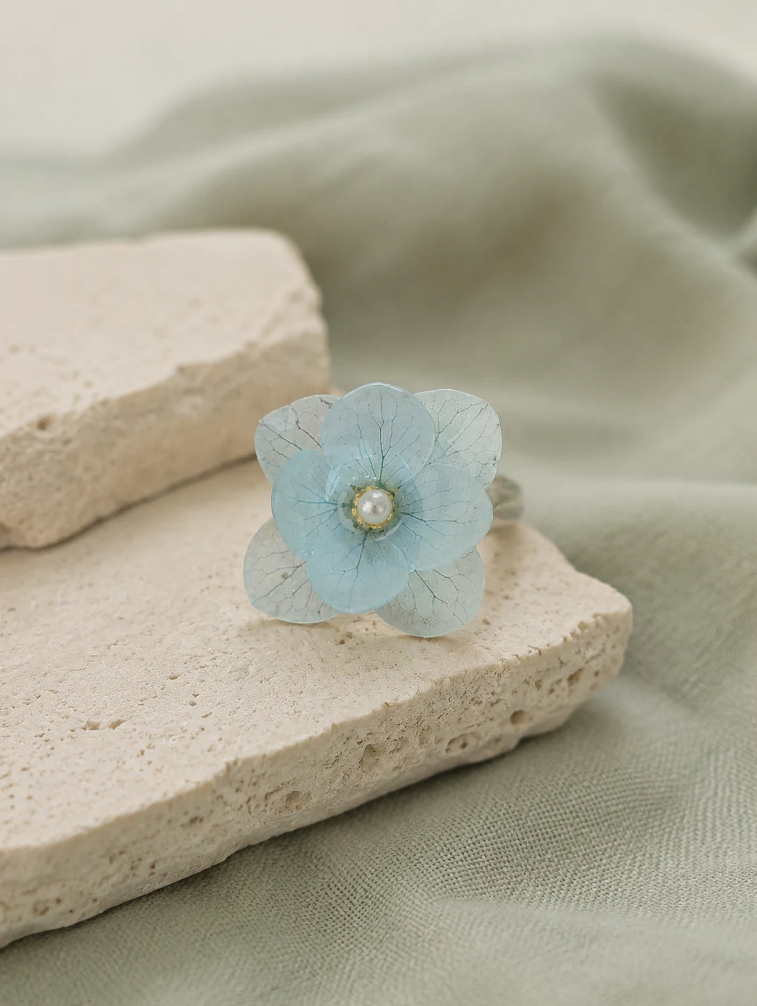 Sky Blue Petal Cluster Ring — restrained editorial still life