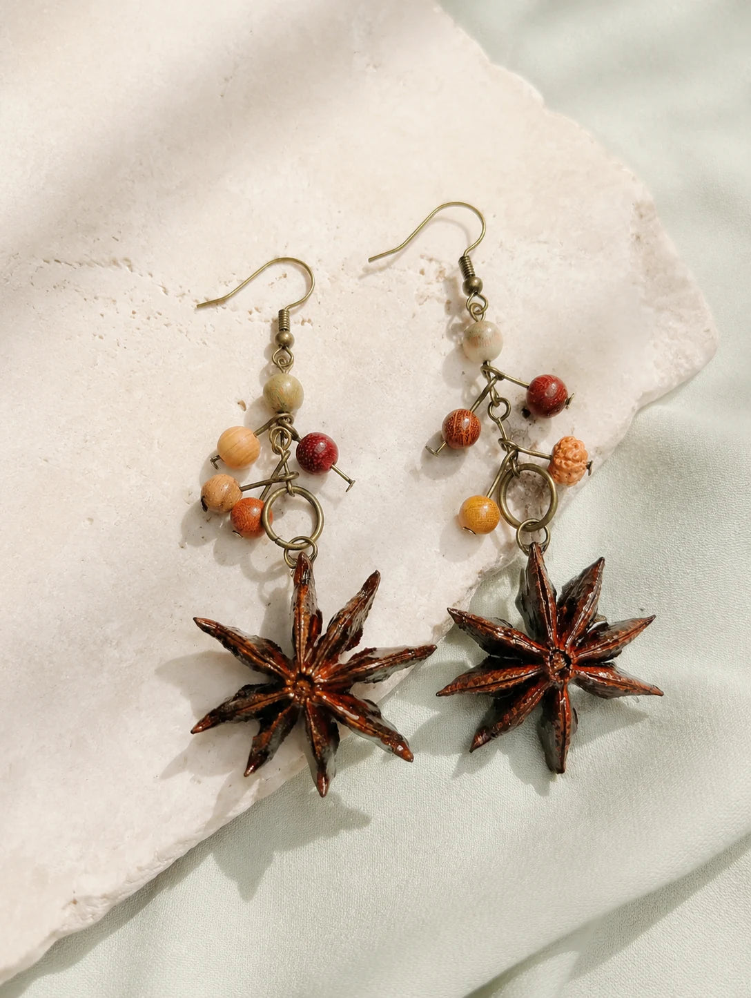 Star Pod Drop Earrings — styled view