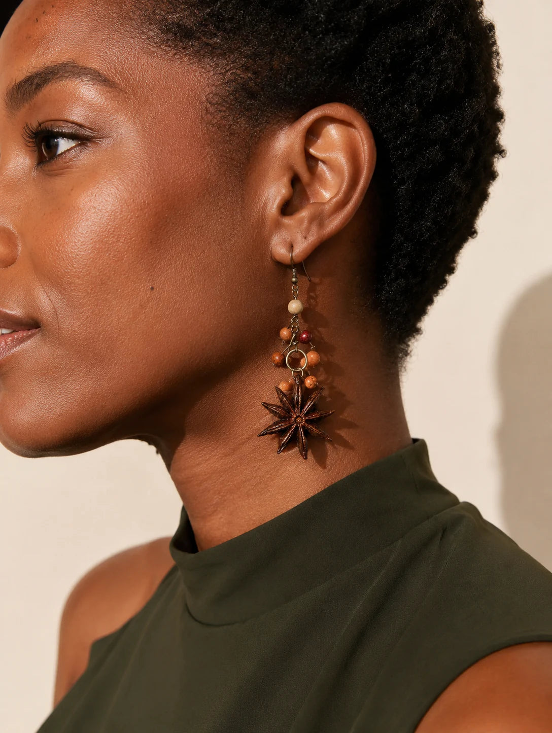 Editorial model styling the Star Pod Drop Earrings