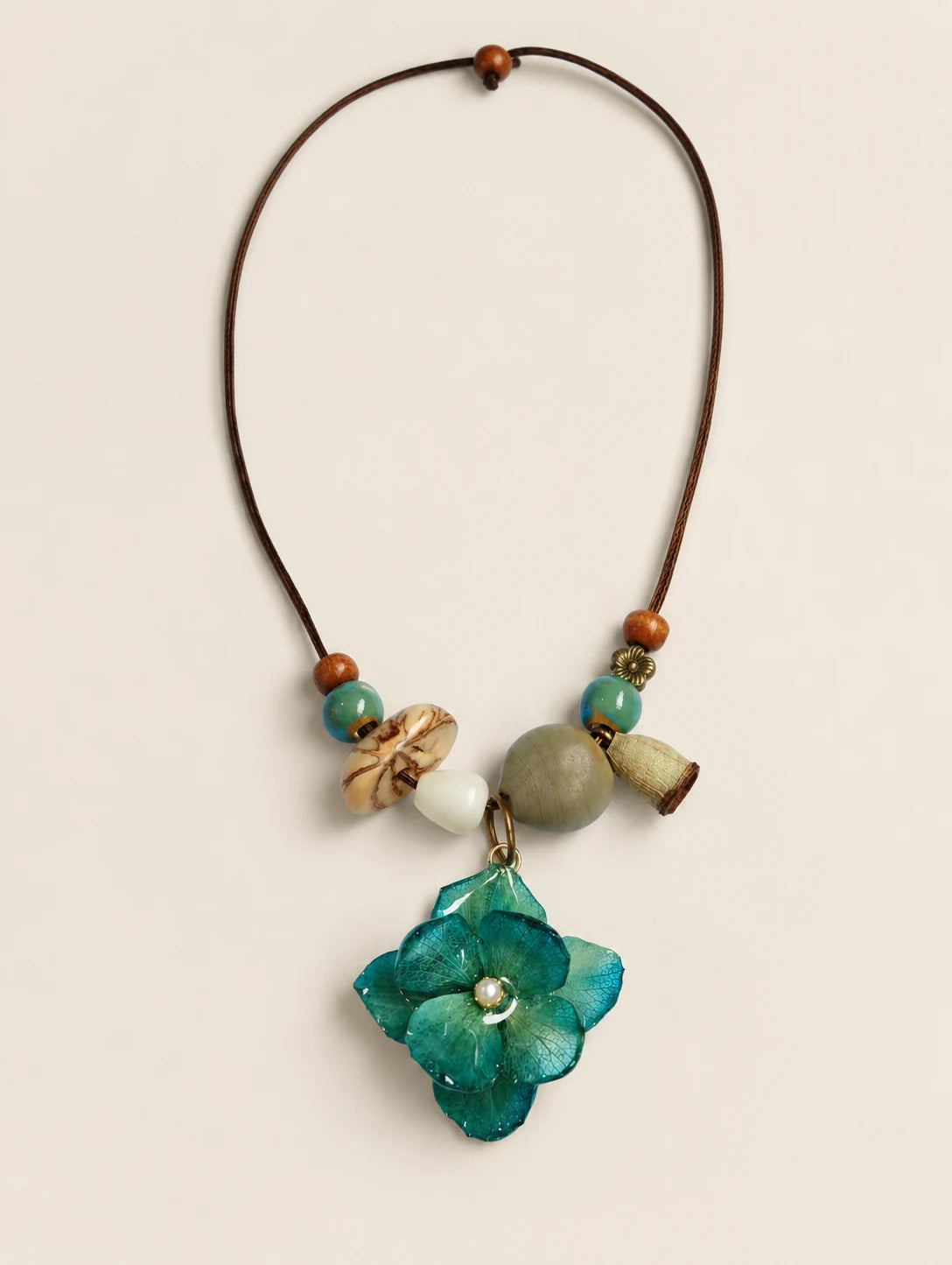 Teal Petal Cluster Necklace — complete product view on a warm ivory background