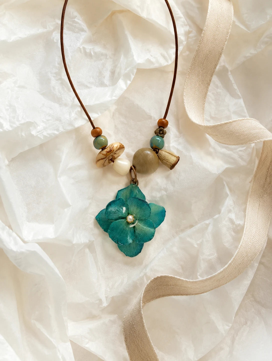 Teal Petal Cluster Necklace — unbranded gift-context still life