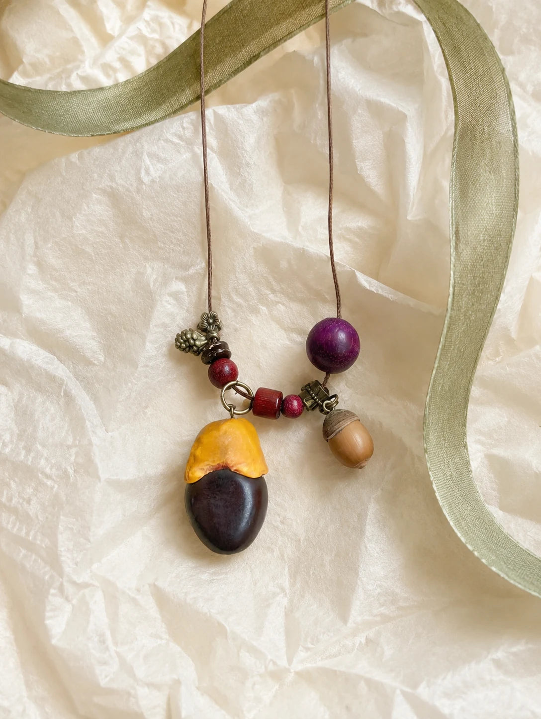 Two-Tone Seed Pendant Necklace — unbranded gift-context still life