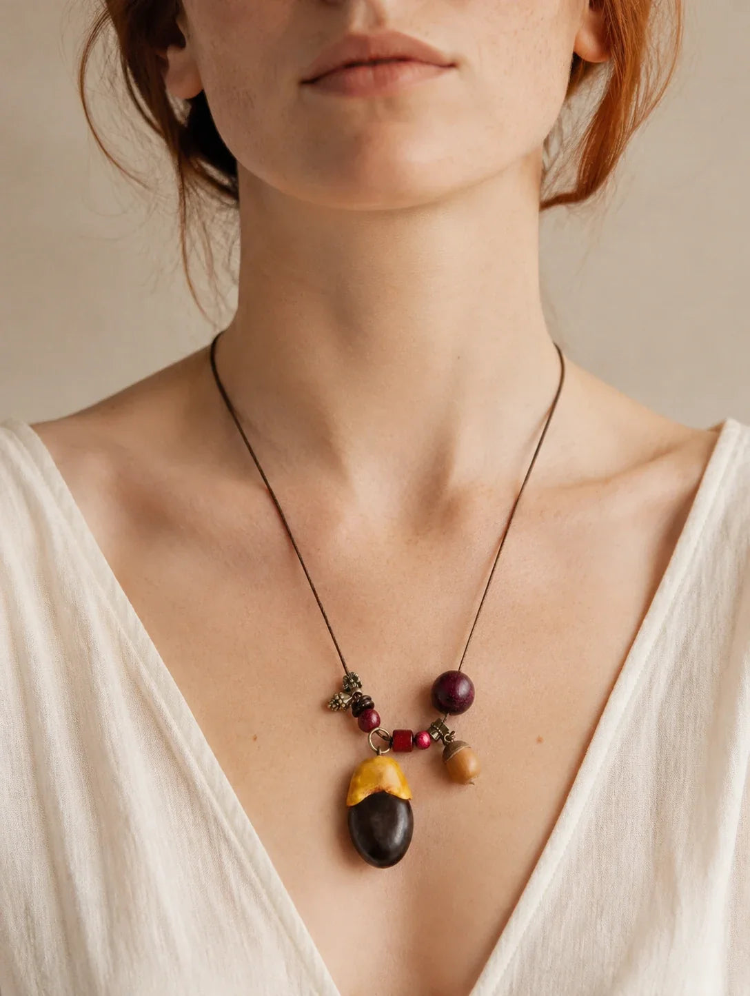 Editorial model styling the Two-Tone Seed Pendant Necklace