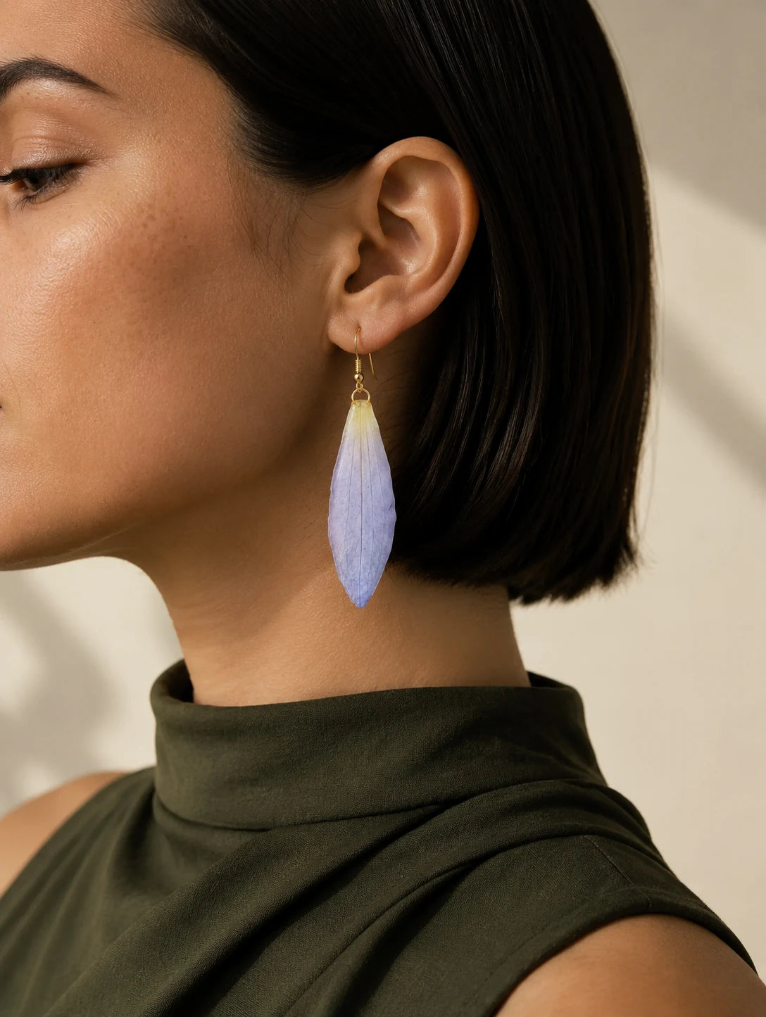 Editorial model styling the Layered Blush Petal Drop Earrings