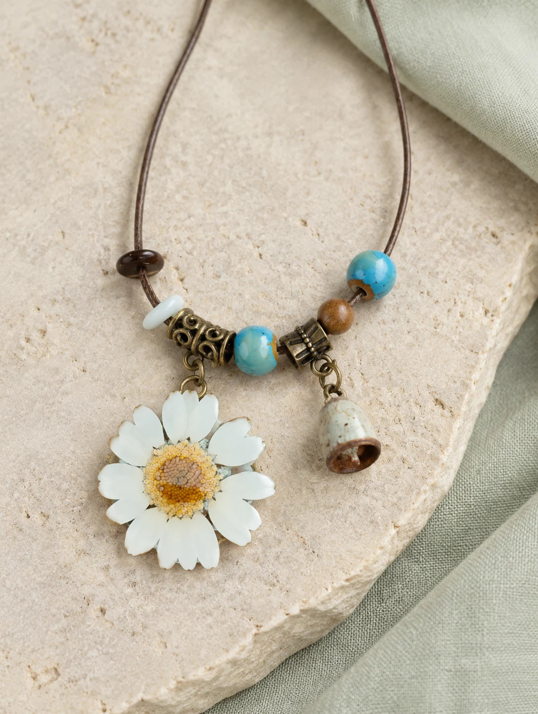 White Petal Token Necklace — restrained editorial still life
