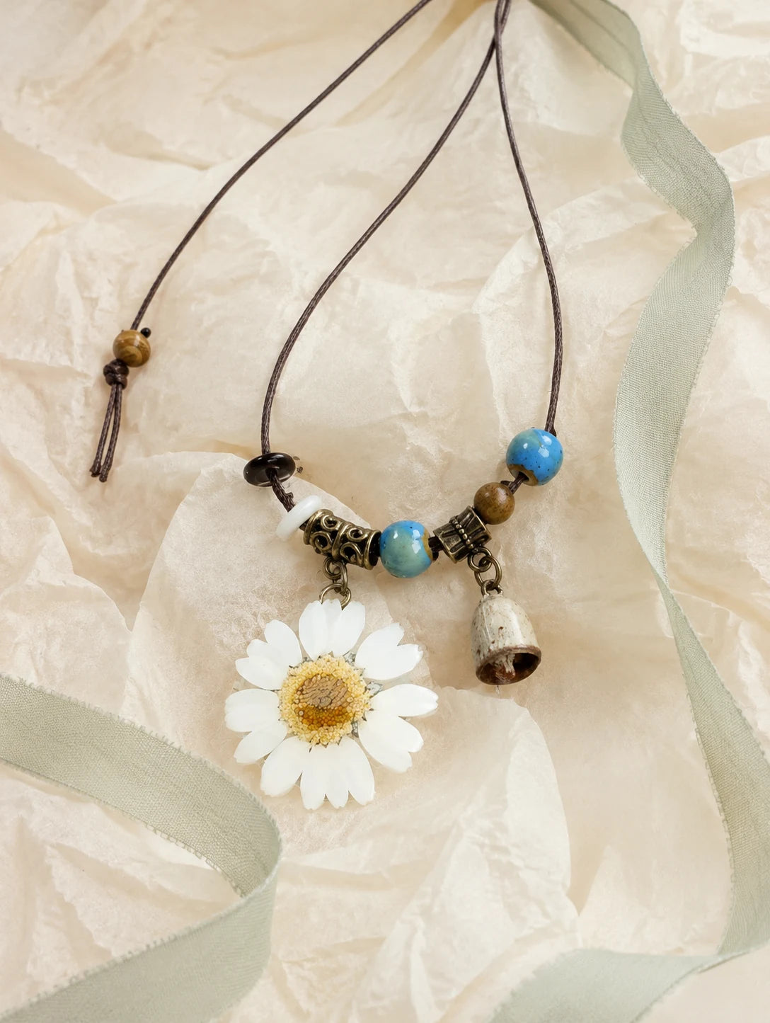 White Petal Token Necklace — unbranded gift-context still life