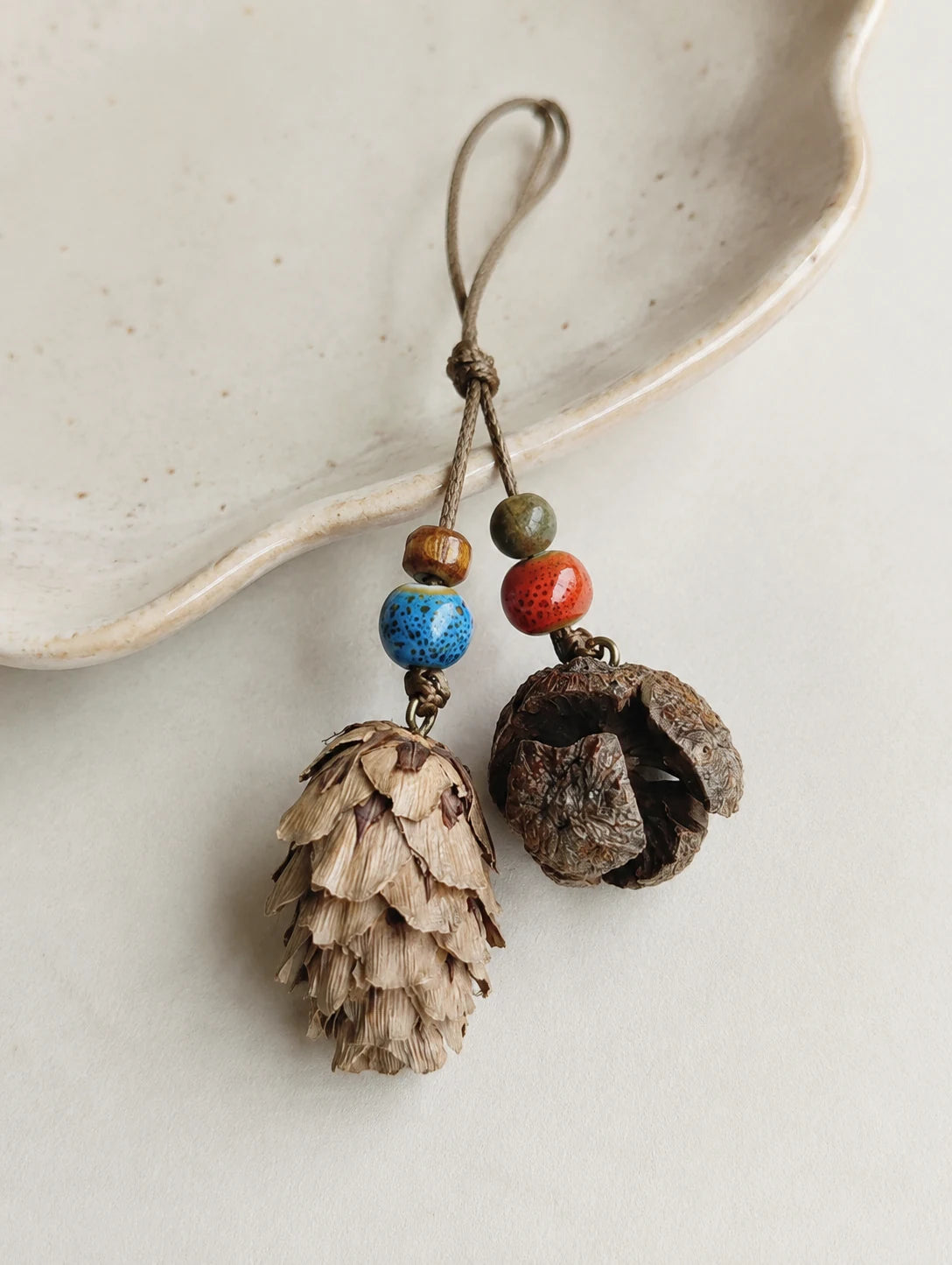 Woodland Cone and Seed Phone Charm — detail view