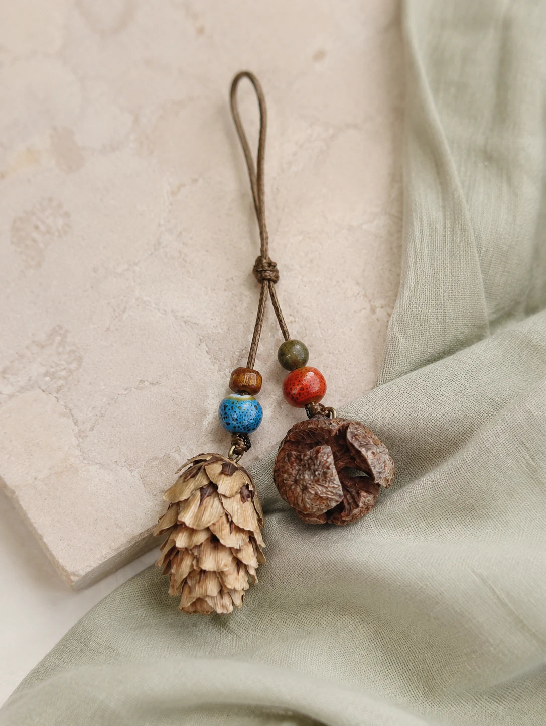 Woodland Cone and Seed Phone Charm — styled view